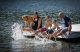 Dog and family on a dock with their feet splashing in the water